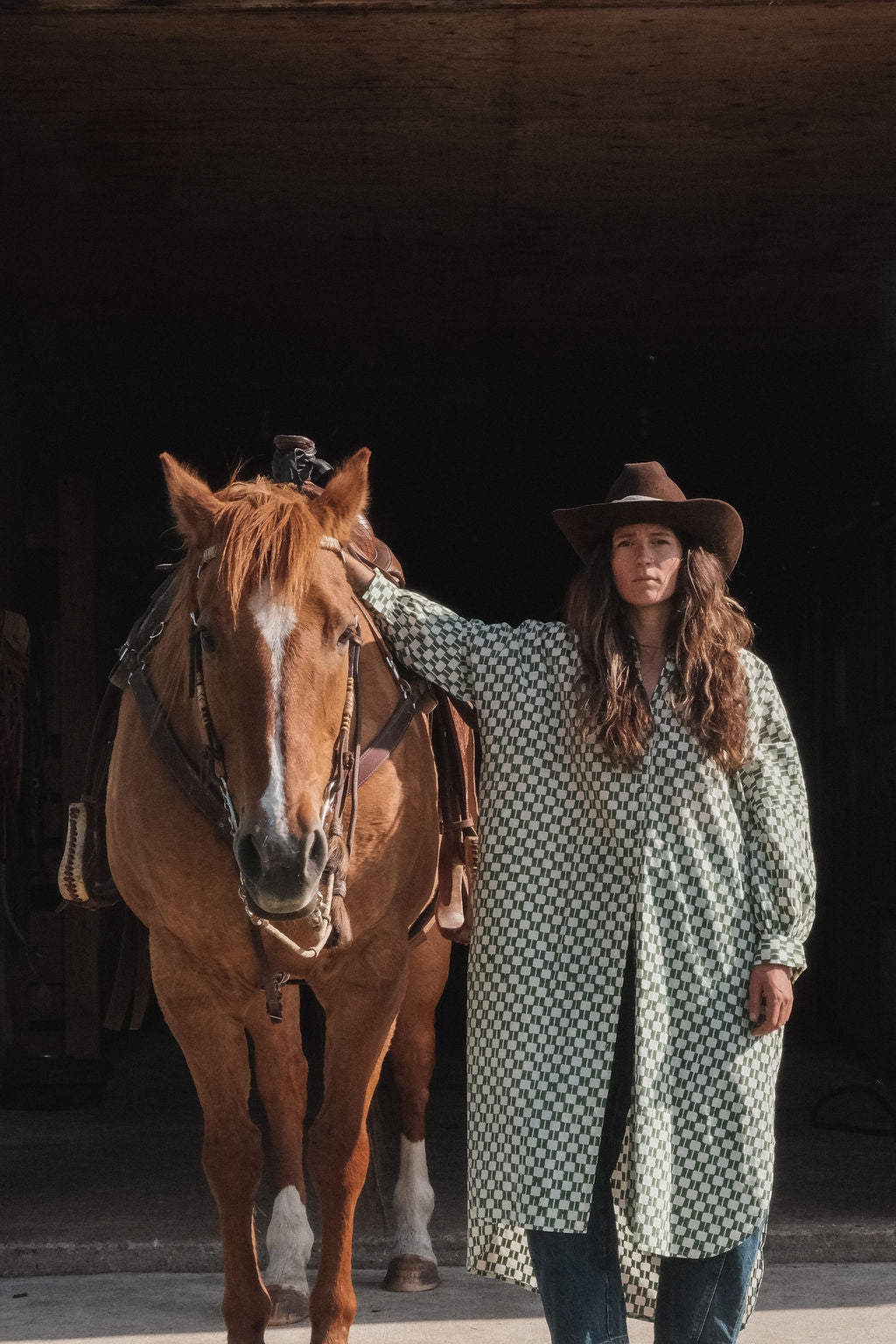Green and white hand block-printed dress made from 100% organic cotton, featuring a front button opening and high-low hemline. Crafted over 5 days using azo-free dyes, the lightweight, non-stretchy fabric feels soft and breathable on the skin. Each piece is ethically made and uniquely one-of-a-kind, with subtle variations in print and color that highlight its artisanal nature. Falls 42” from the shoulder, offering a relaxed silhouette that fits true to size.