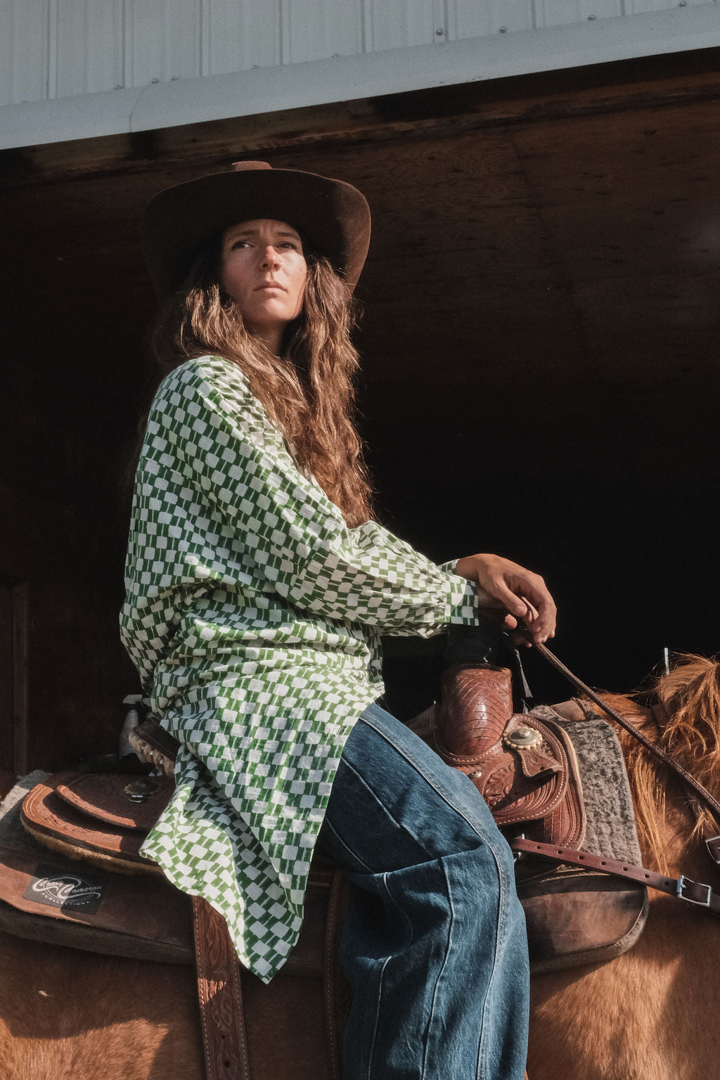 Green and white hand block-printed dress made from 100% organic cotton, featuring a front button opening and high-low hemline. Crafted over 5 days using azo-free dyes, the lightweight, non-stretchy fabric feels soft and breathable on the skin. Each piece is ethically made and uniquely one-of-a-kind, with subtle variations in print and color that highlight its artisanal nature. Falls 42” from the shoulder, offering a relaxed silhouette that fits true to size.