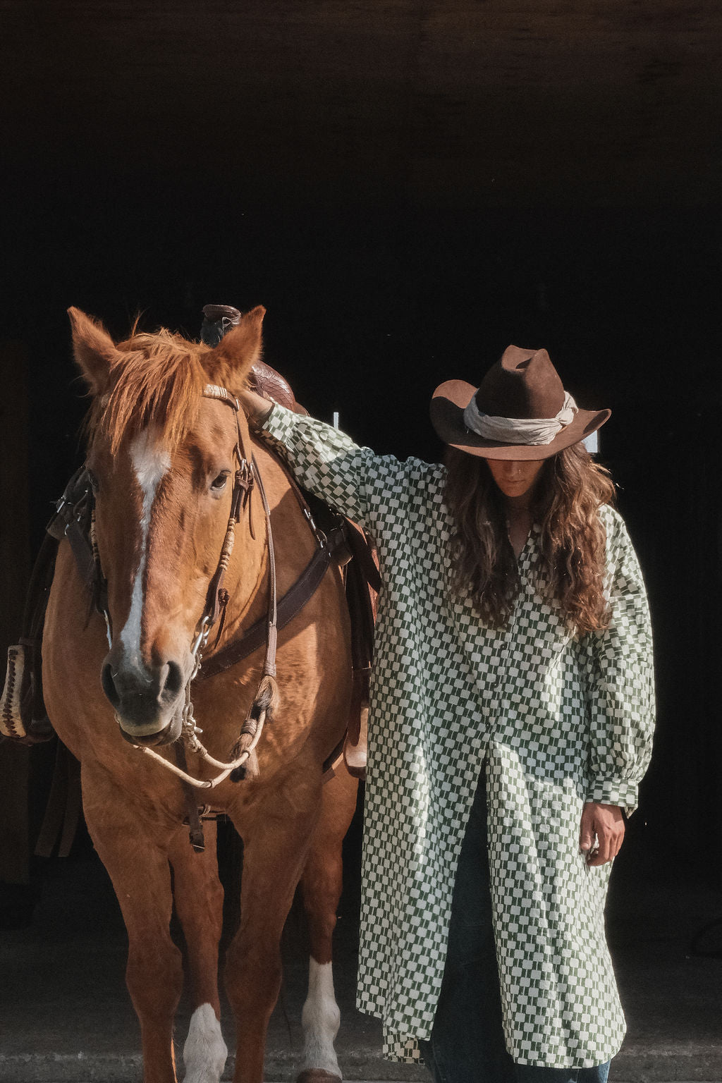 Green and white hand block-printed dress made from 100% organic cotton, featuring a front button opening and high-low hemline. Crafted over 5 days using azo-free dyes, the lightweight, non-stretchy fabric feels soft and breathable on the skin. Each piece is ethically made and uniquely one-of-a-kind, with subtle variations in print and color that highlight its artisanal nature. Falls 42” from the shoulder, offering a relaxed silhouette that fits true to size.