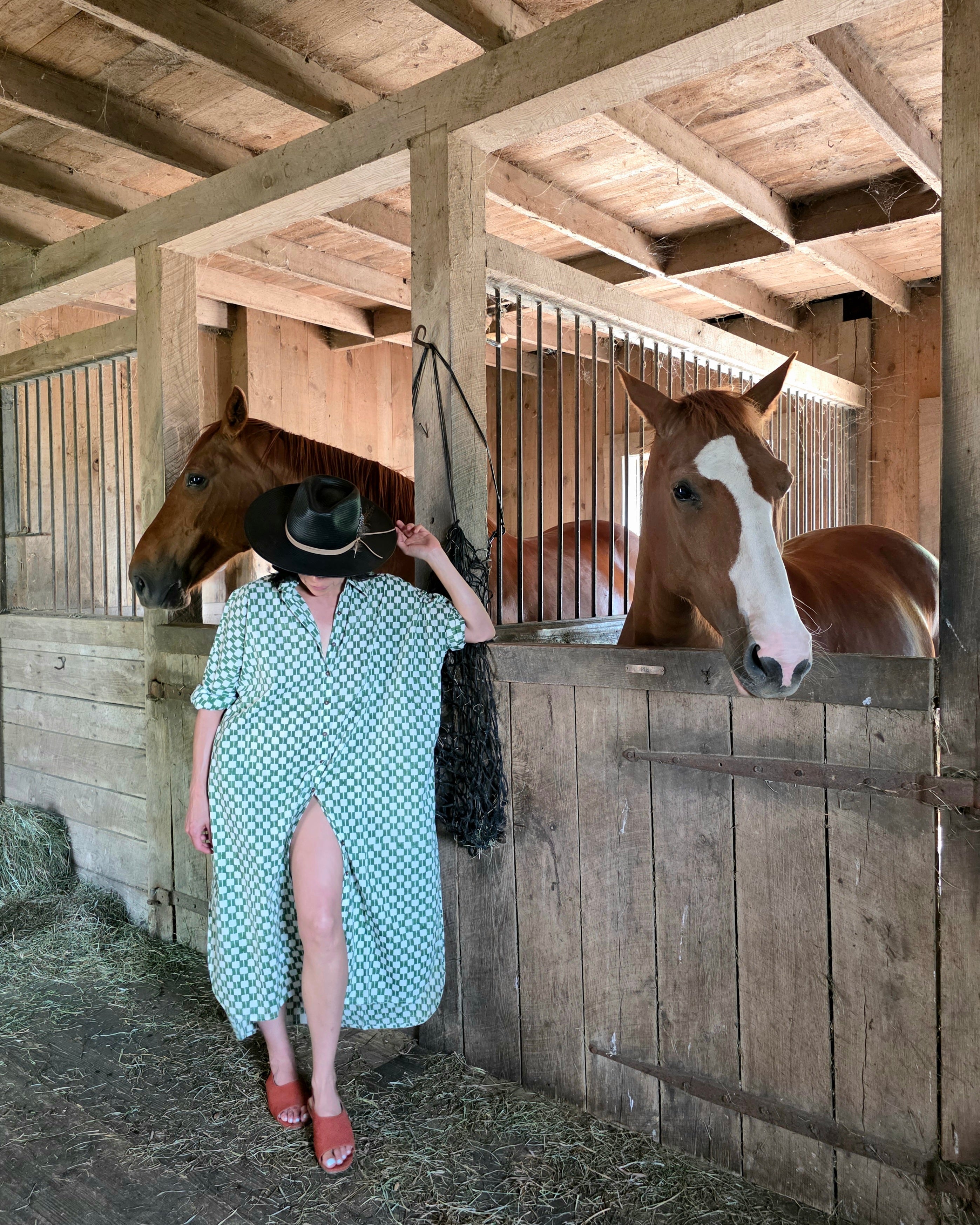Green and white hand block-printed dress made from 100% organic cotton, featuring a front button opening and high-low hemline. Crafted over 5 days using azo-free dyes, the lightweight, non-stretchy fabric feels soft and breathable on the skin. Each piece is ethically made and uniquely one-of-a-kind, with subtle variations in print and color that highlight its artisanal nature. Falls 42” from the shoulder, offering a relaxed silhouette that fits true to size.