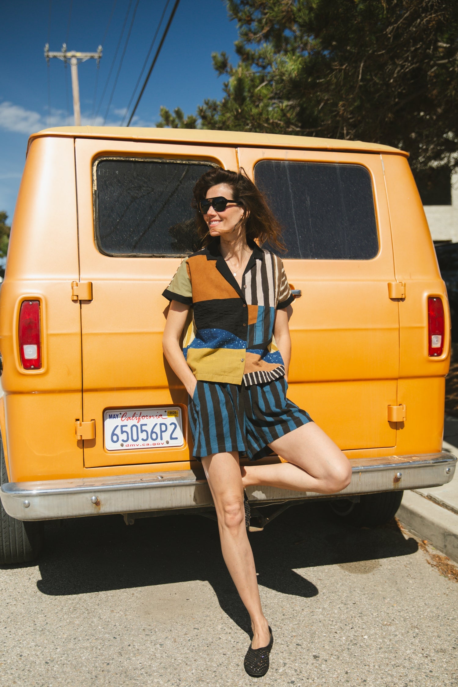 Color-blocked patchwork short-sleeve shirt featuring bold striped and solid fabric panels in earthy tones. Designed with a relaxed fit, button-down front, and a sharp collar for a modern, eclectic look.