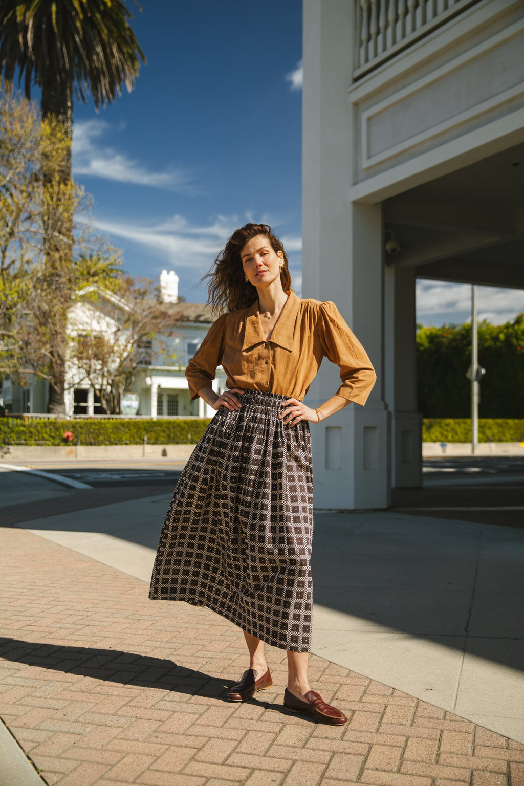Black and white printed midi skirt with an elastic waistband, featuring a geometric pattern, flowy silhouette, and lightweight fabric for an effortlessly chic and comfortable style.