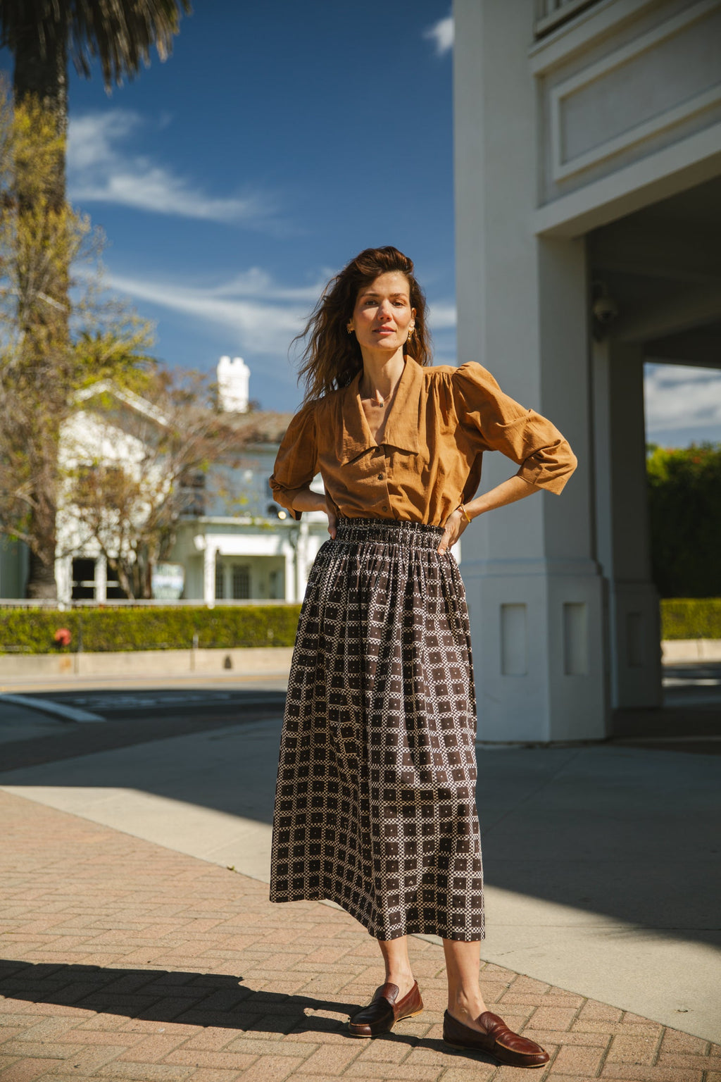 Black and white printed midi skirt with an elastic waistband, featuring a geometric pattern, flowy silhouette, and lightweight fabric for an effortlessly chic and comfortable style.