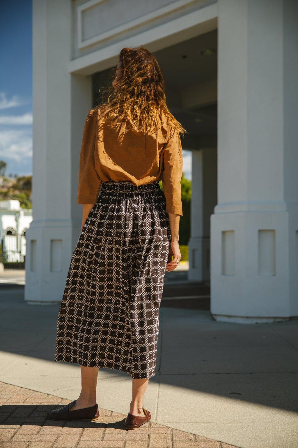 Black and white printed midi skirt with an elastic waistband, featuring a geometric pattern, flowy silhouette, and lightweight fabric for an effortlessly chic and comfortable style.