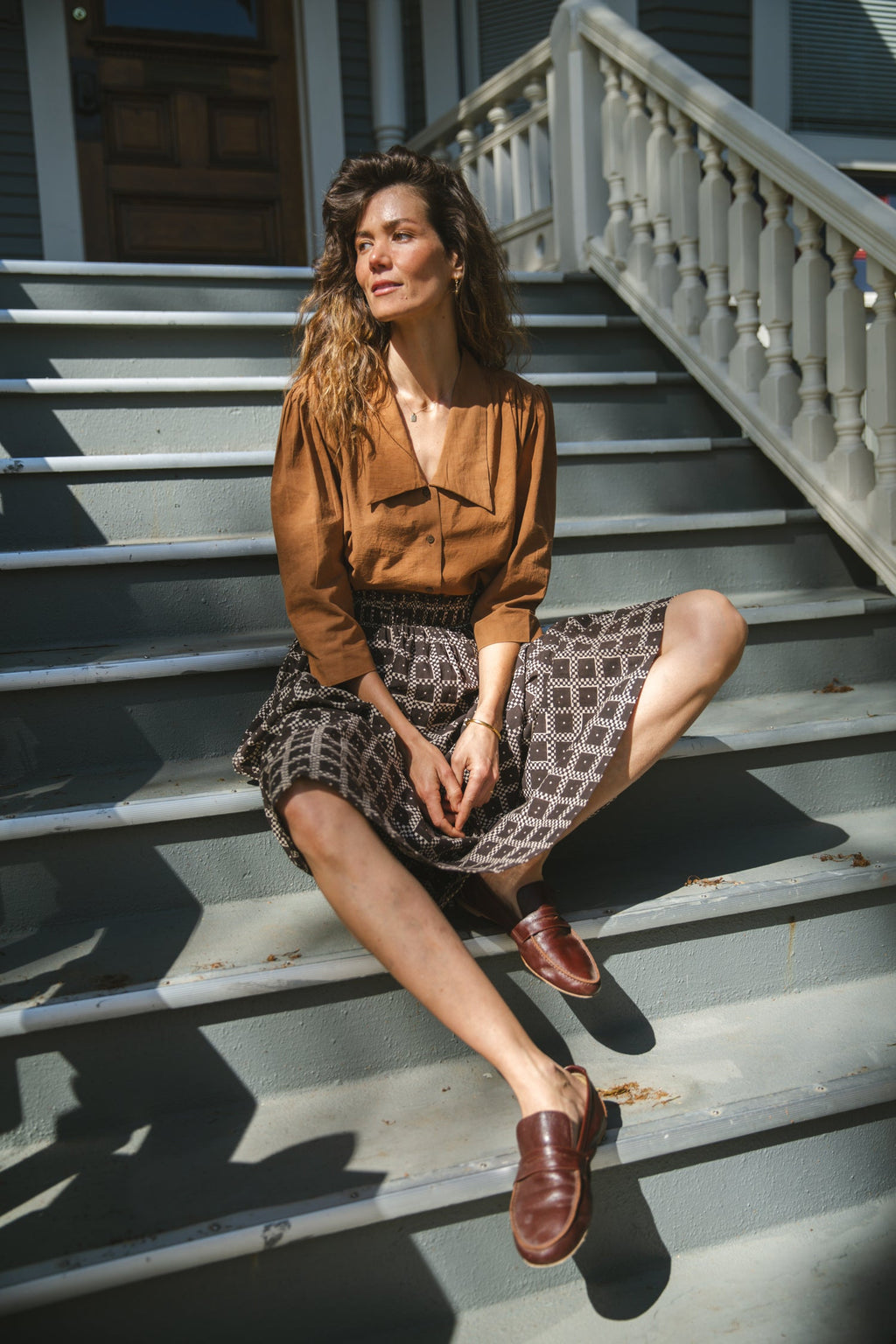 Black and white printed midi skirt with an elastic waistband, featuring a geometric pattern, flowy silhouette, and lightweight fabric for an effortlessly chic and comfortable style.