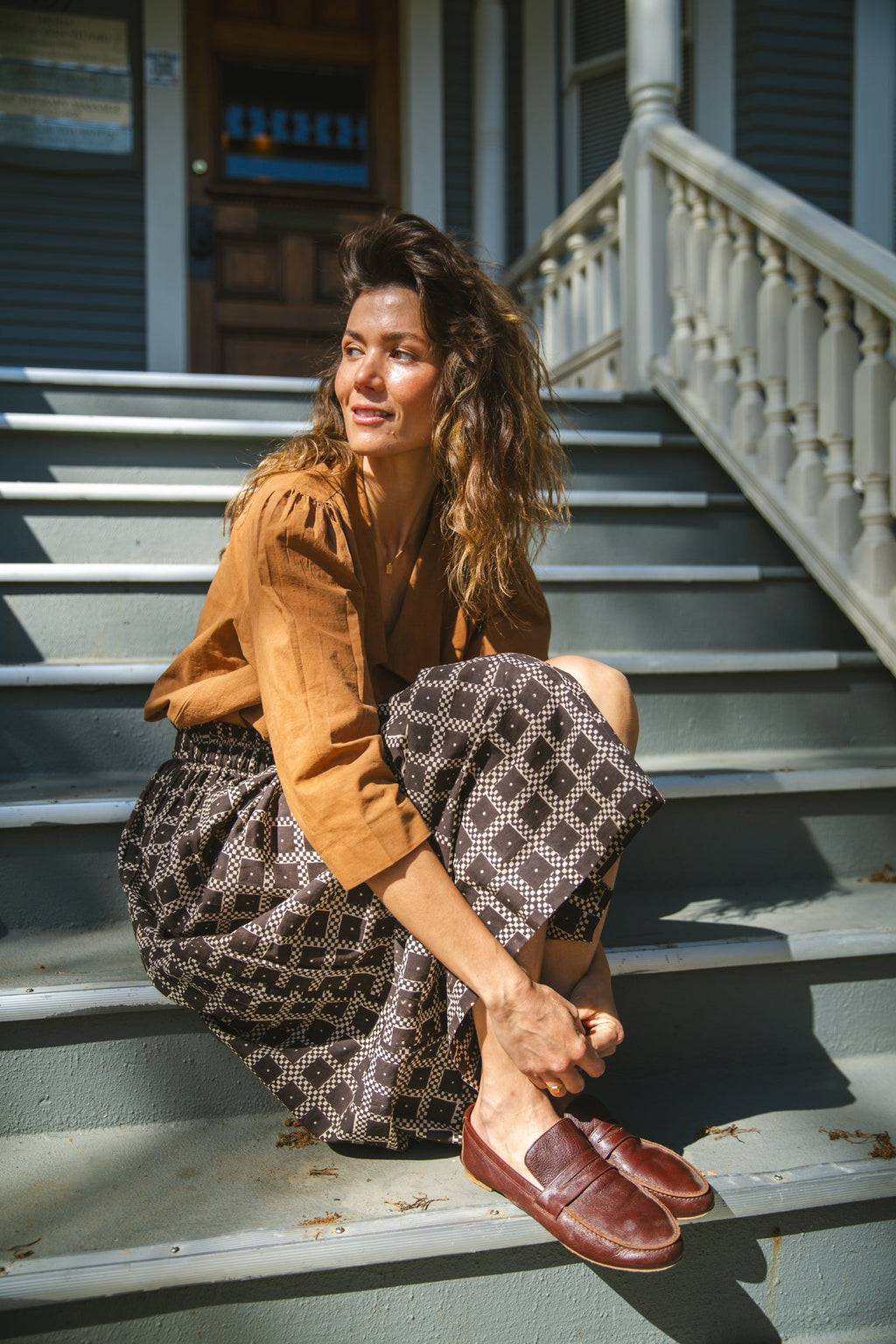 Black and white printed midi skirt with an elastic waistband, featuring a geometric pattern, flowy silhouette, and lightweight fabric for an effortlessly chic and comfortable style.