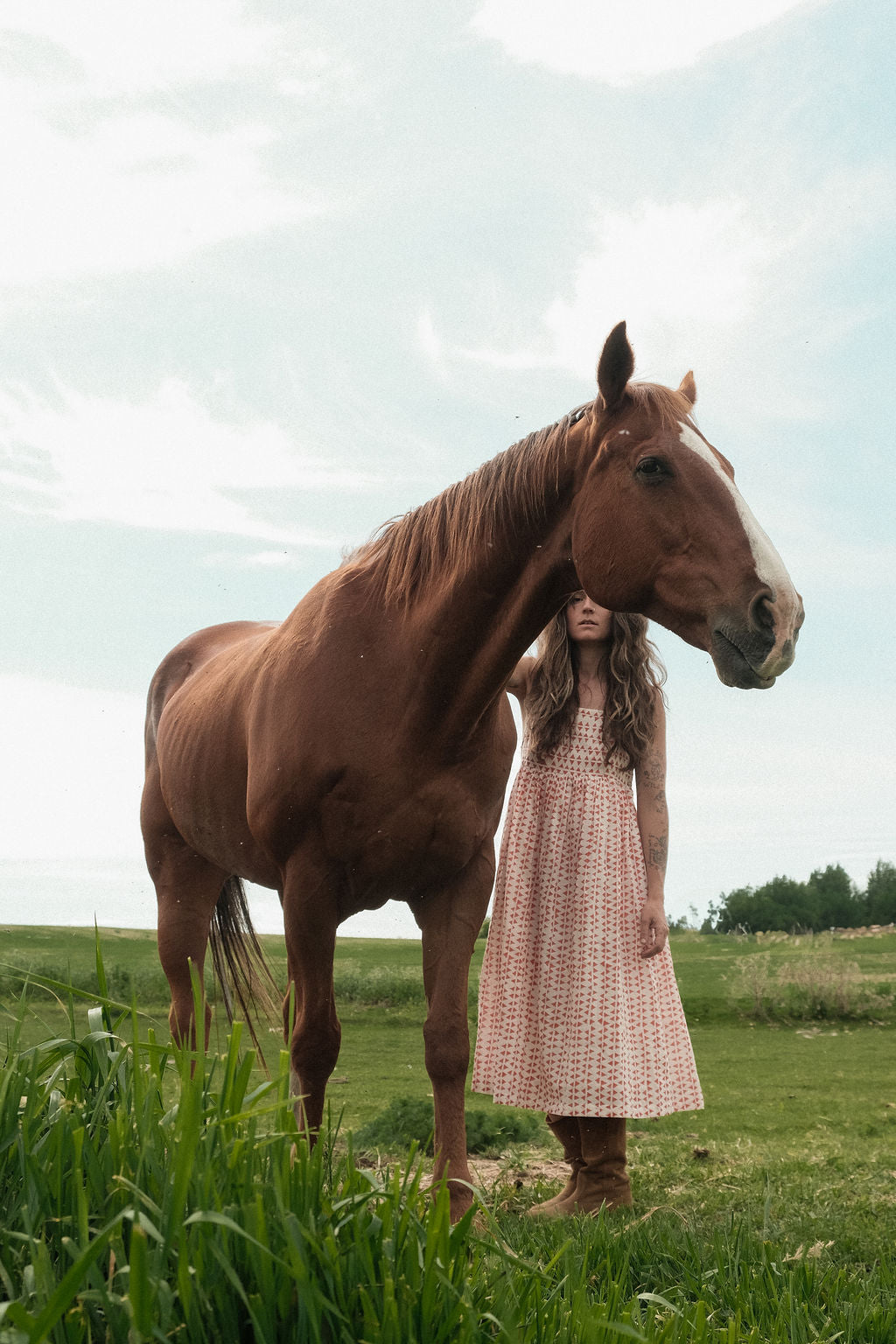 This is dress is the quintessential example of a sundress - perfect for get-outs and adventures. The flowy garment is made with azo free dye with tiny red triangle on a white base. Each triangle being unique as printed by a hand block. 