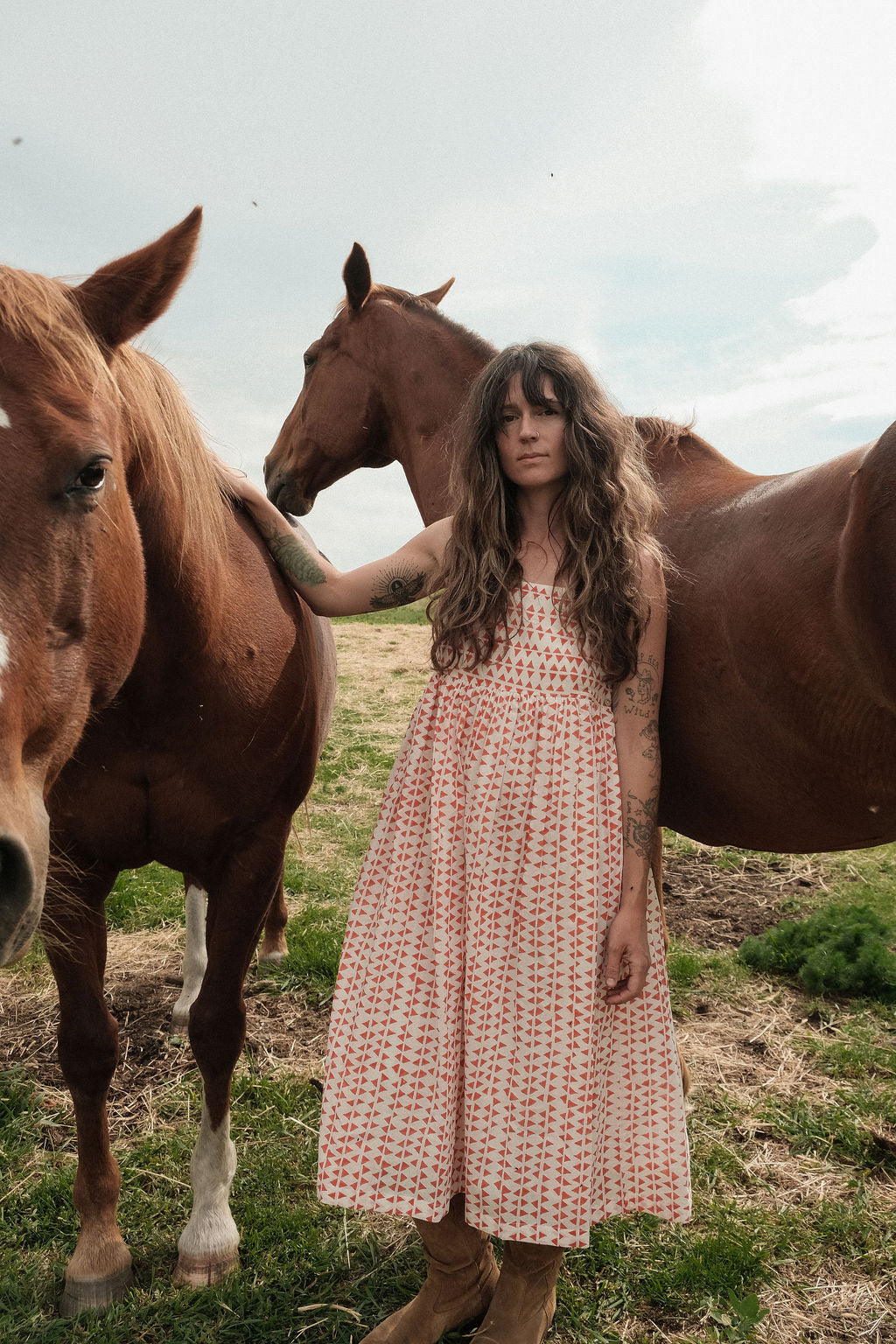 This is dress is the quintessential example of a sundress - perfect for get-outs and adventures. The flowy garment is made with azo free dye with tiny red triangle on a white base. Each triangle being unique as printed by a hand block. 