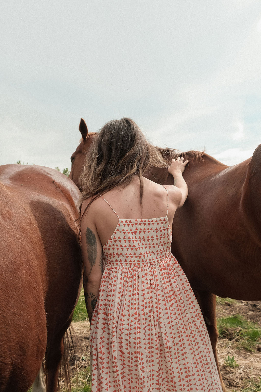 This is dress is the quintessential example of a sundress - perfect for get-outs and adventures. The flowy garment is made with azo free dye with tiny red triangle on a white base. Each triangle being unique as printed by a hand block. 