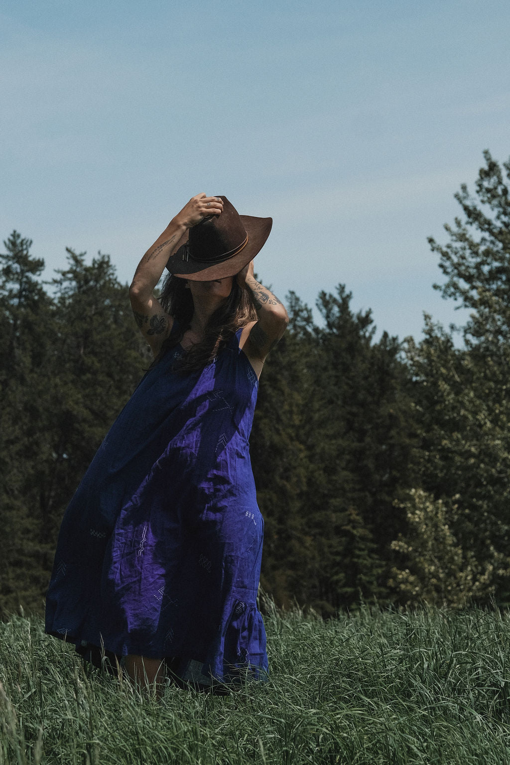 Long indigo blue Jamdani dress featuring wide straps, a gathered neckline, and subtle white abstract geometric motifs. Handwoven from soft, lightweight cotton and dyed with azo-free dyes, this fully lined dress is crafted over 7 days using traditional weaving techniques. Ethically made with a relaxed, bohemian silhouette, it's perfect for summer wear—combining artisanal charm with breathable comfort.