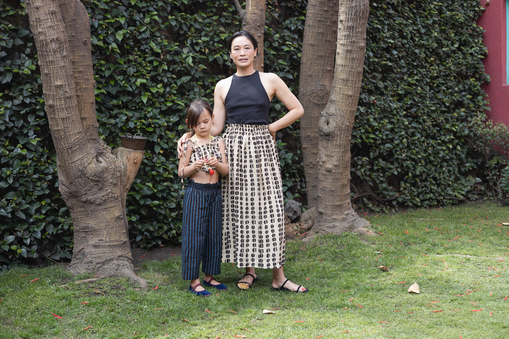 A lightweight, flowing midi skirt crafted from soft, breathable fabric. The design features a hand-blocked polka dot print in an organic, artisanal pattern, adding a unique touch to the neutral base. The elasticated waistband offers comfort and a flexible fit for its effortless, relaxed feel.
