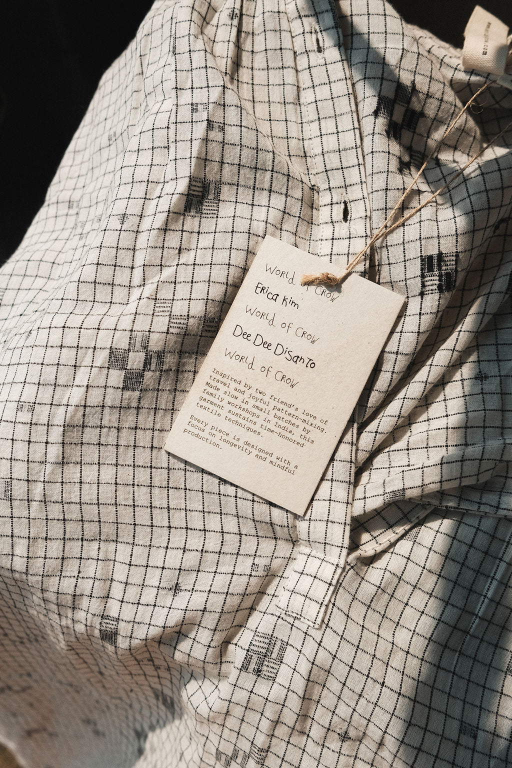 Details of the dress's fabric featuring checkered pattern with scattered motif in jamdani.