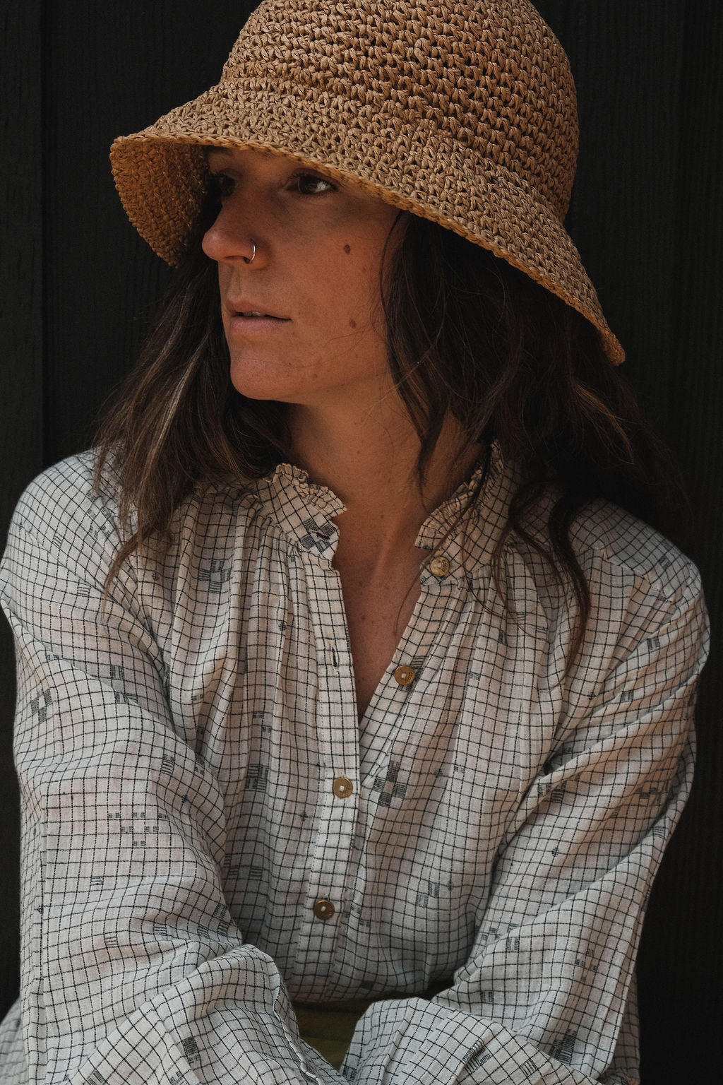 This Jamdani dress made with handwoven cotton is a perfect summer dress with its light color detailed square black threads. It has long sleeves with ruffles along a ruffled neck, and a midi length. 
