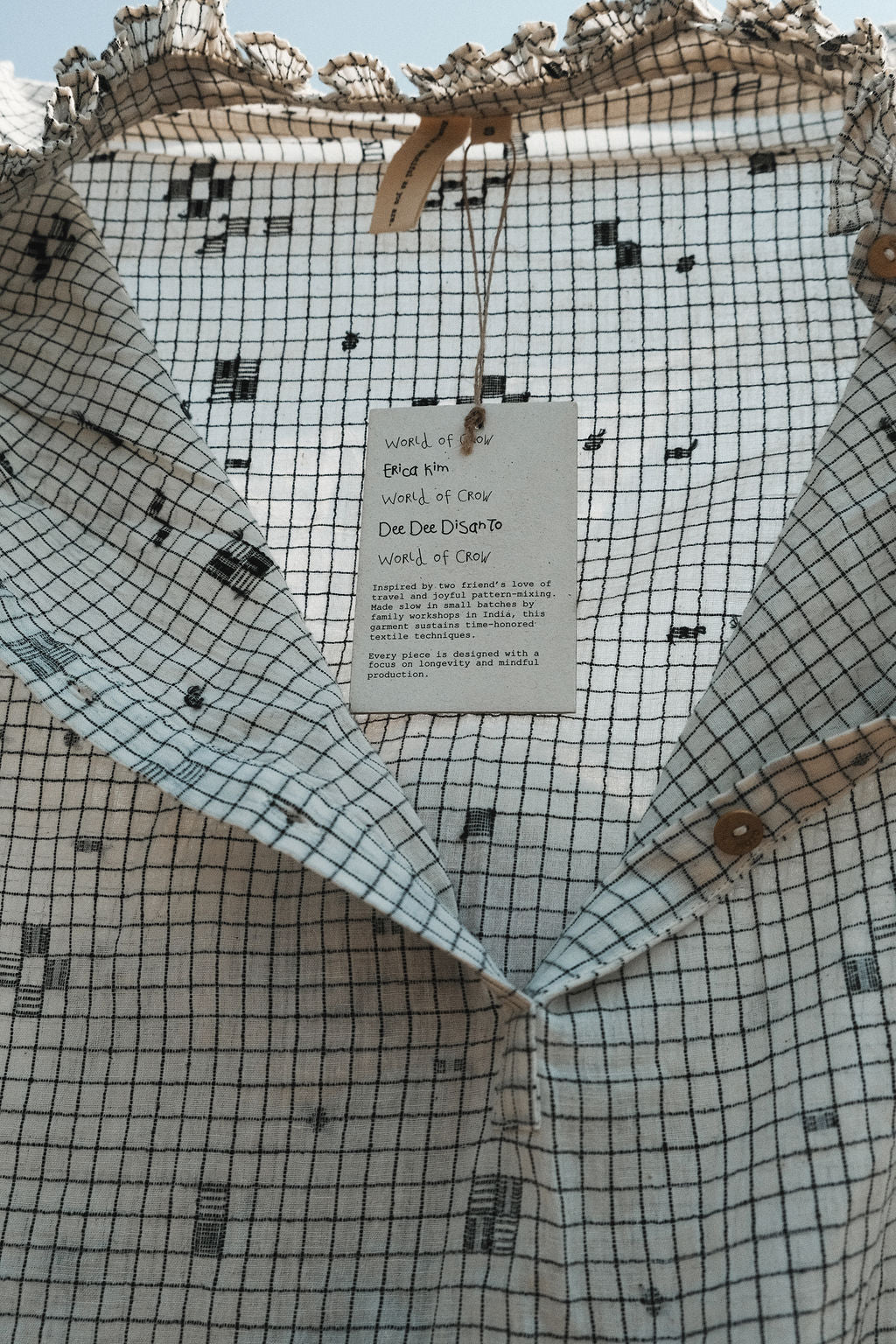 Details of the dress's fabric featuring checkered pattern with scattered motif in jamdani.