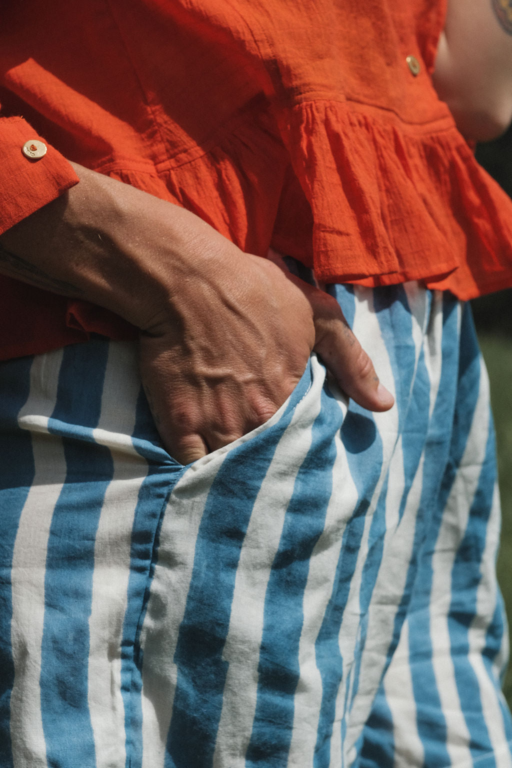 These shorts are perfect for everyday wear, has side pockets, made with soft organic fabric, in striped blue & white color. 