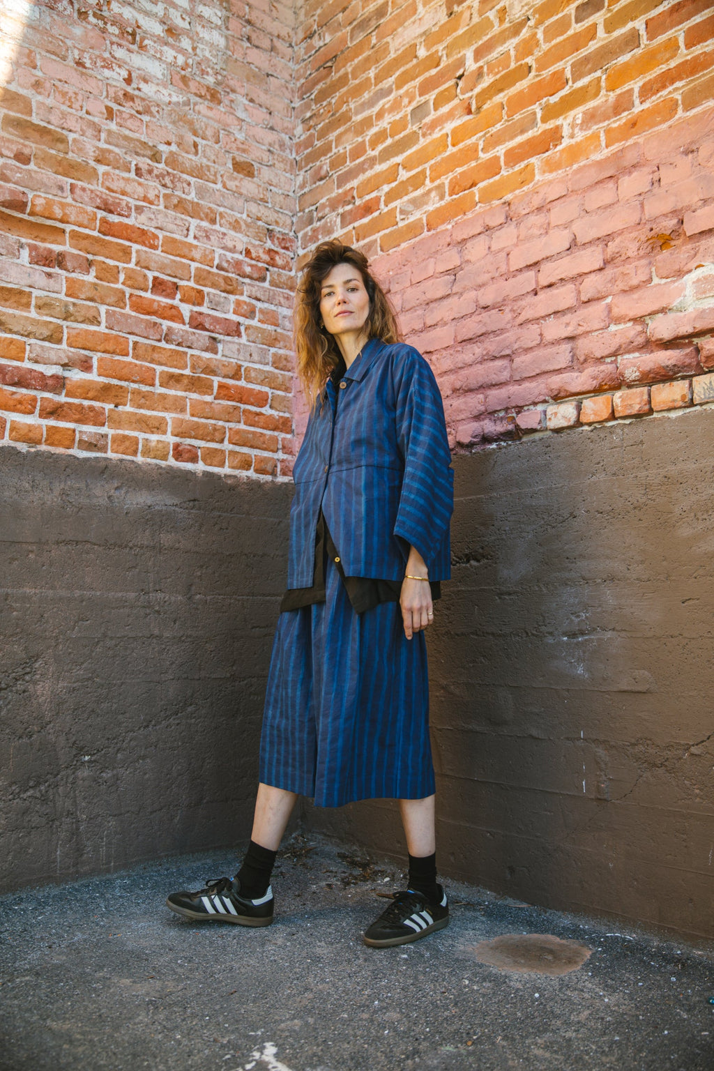 Blue striped midi skirt with a flowy silhouette, featuring an elastic waistband for comfort and movement.
