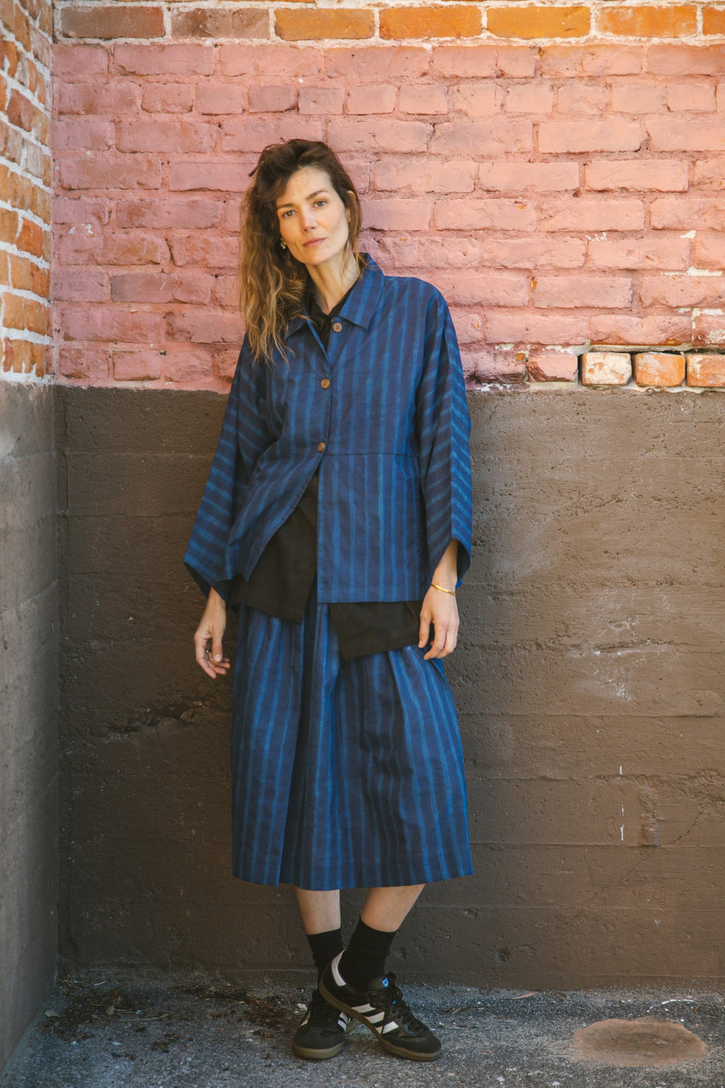 Blue striped midi skirt with a flowy silhouette, featuring an elastic waistband for comfort and movement.
