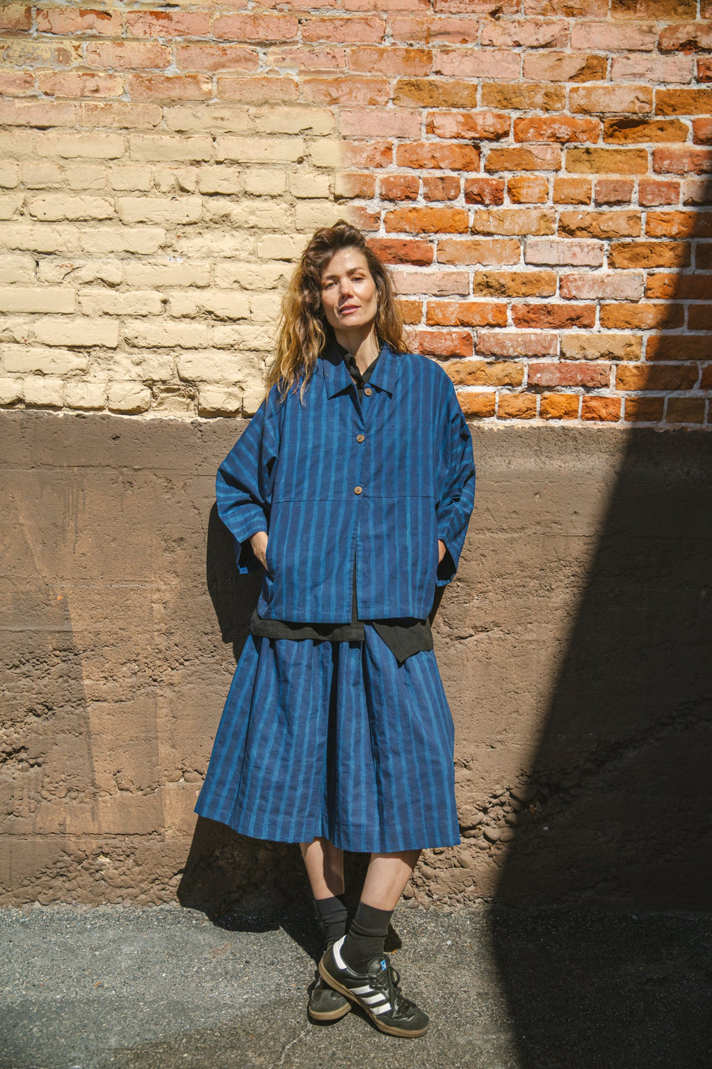 Blue striped midi skirt with a flowy silhouette, featuring an elastic waistband for comfort and movement.
