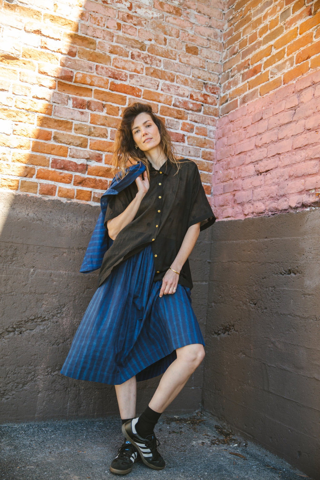 Blue striped midi skirt with a flowy silhouette, featuring an elastic waistband for comfort and movement.