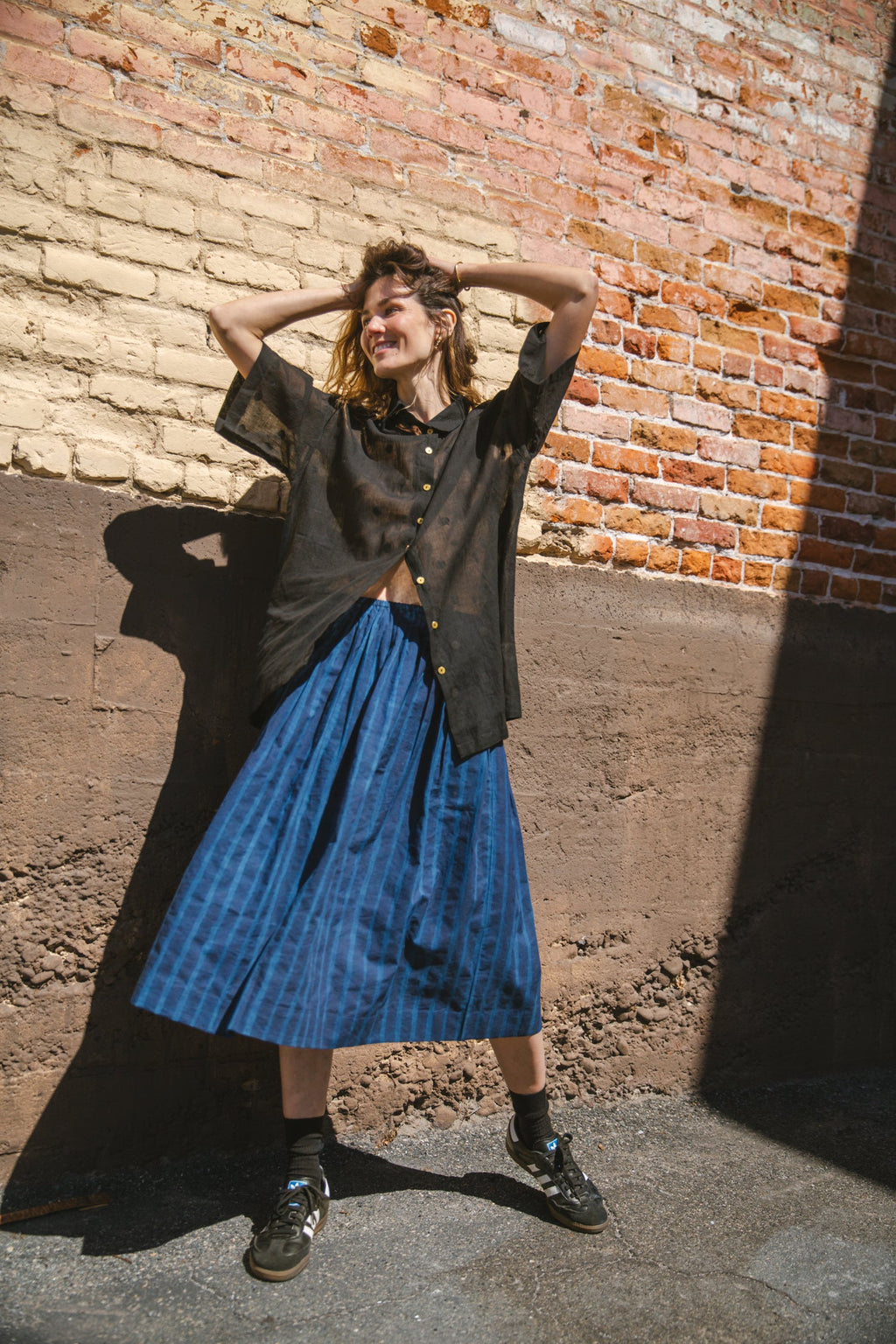 Blue striped midi skirt with a flowy silhouette, featuring an elastic waistband for comfort and movement.
