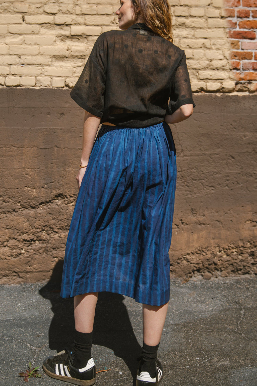 Blue striped midi skirt with a flowy silhouette, featuring an elastic waistband for comfort and movement.