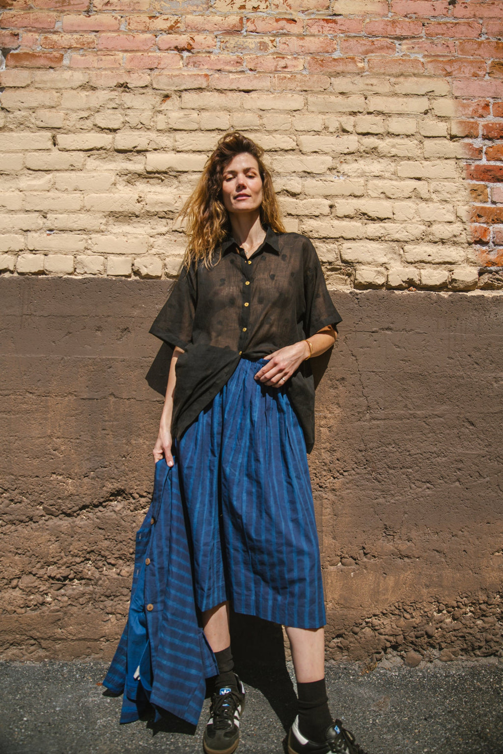 Blue striped midi skirt with a flowy silhouette, featuring an elastic waistband for comfort and movement.