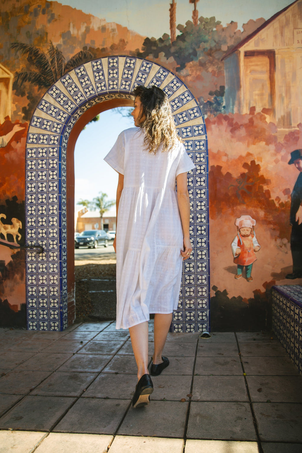White A-line midi dress with cap sleeves, a button-down front, a gathered waist, it has delicate checks adding a texture to the garment. Made from lightweight, breathable fabric for a relaxed fit.