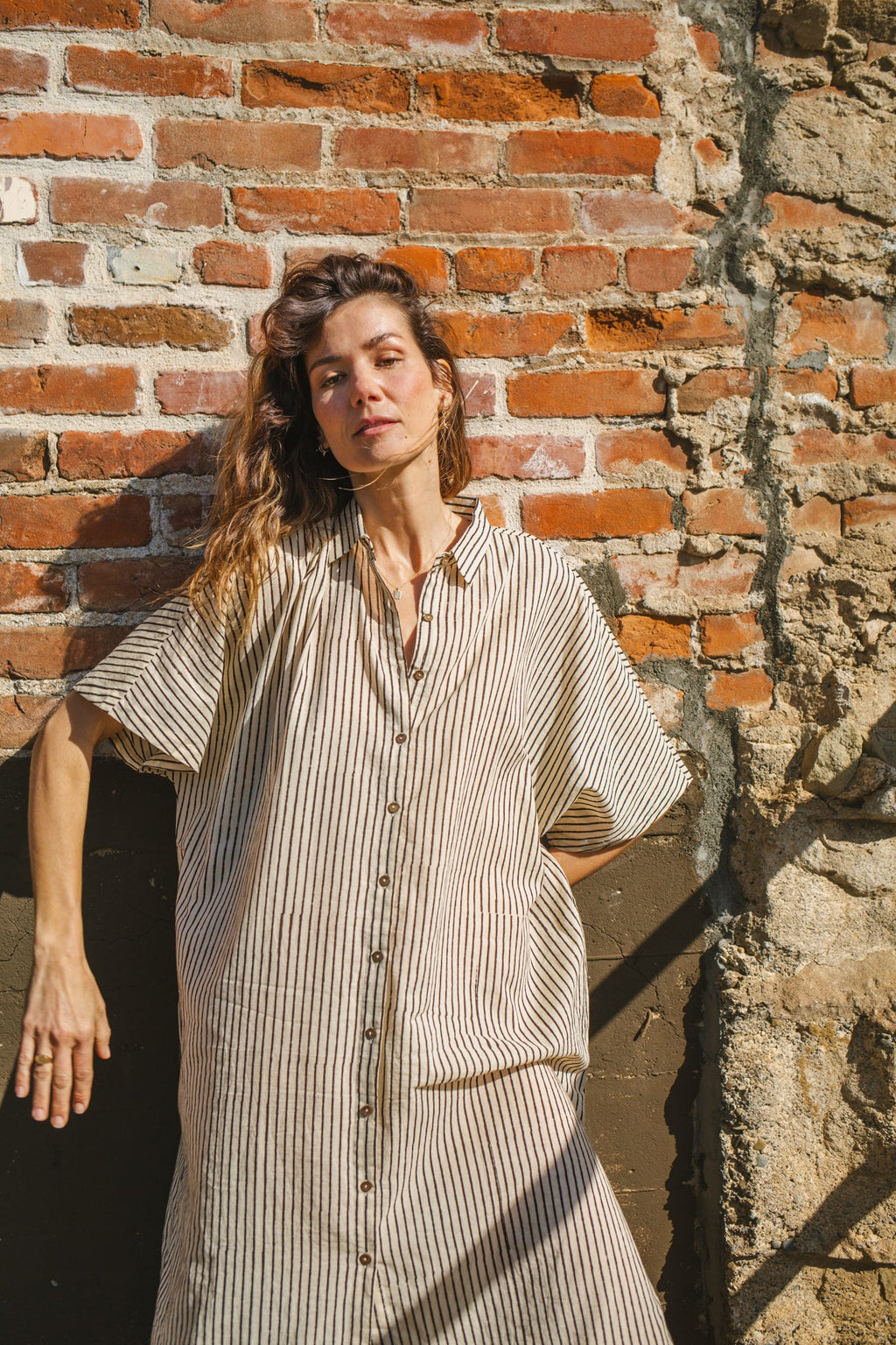 Black and white striped zebra-print shirt dress with a relaxed fit, lightweight breathable fabric, and subtle textured pattern for a stylish and comfortable look.
